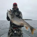 Man on boat with Huge Walleye Fish