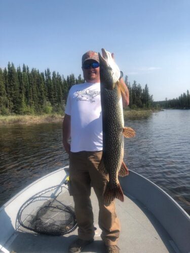Man Showing Off Fish caught in Reindeer Lake