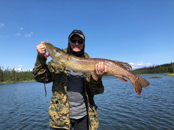 Man Proudly Displaying a Northern Pike